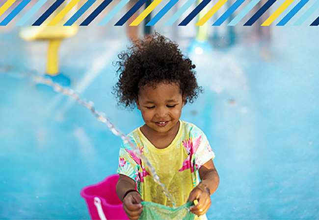 young child playing in the water